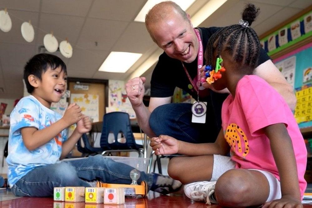 Teacher and two students with blocks