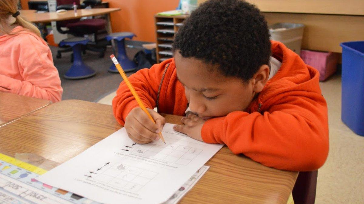 boy writing on paper